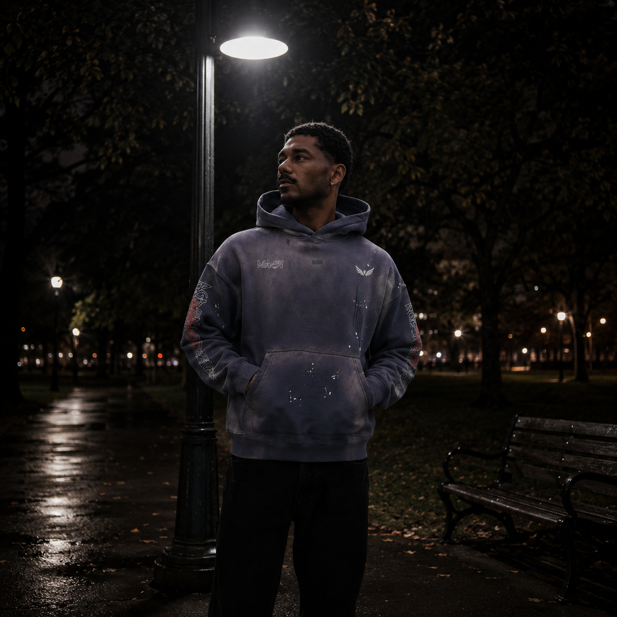 Person wearing a vintage washed heavyweight oversized hoodie standing under a street lamp in a park at night, showcasing premium Australian streetwear style.